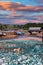 Fishing wharf in St. Martins, New Brunswick, Canada on low tide with  boats in mud, a covered bridge in the background and lobster