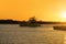 Fishing yacht power boat leaving bay at sunrise to catch fish