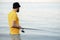 Fishing young man with sport fish rod for recreation on summer day. Recreational fishing fisherman outdoor leisure