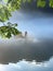 A fishman cast a net in the fog on the river