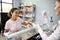 Fishmonger serving customer of fish store. Mixed race woman, purchaser tasting caviar at seafood shop