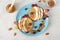 Fishs-shaped pancakes with peaches, berries, granola and almonds on a blue plate, healthy breakfast idea for kids, top