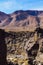 Fissile Falls canyon and desert mountains beyond in morning sunlight