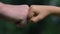 Fist bump of adult man and little boy closeup, mens friendship, family support