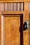 Fist door knocker on brown wooden door