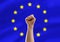 fist or hand punching air over european union flag