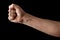 Fist isolated on black background. A strong man raised his fist on a black background, power, protest, fist ready for battle