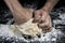 Fist pressing a ball of kneaded flour to make bread