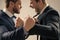 fist of punching disagreed men business partners or colleague disputing, selective focus, corporate battle.