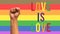 fist up with lgbt flag with text love is love