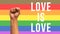 fist up with lgbt flag with text love is love in white color