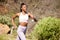 Fit and active African American woman running alone outside for a workout. Ambitious black athlete training and