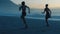 Fit, active and athletic women running, racing and competing on beach workout at sunrise. Sporty and powerful athletes