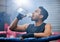 Fit, active and healthy boxer drinking water, on break and staying hydrated in routine workout, training or boxing ring