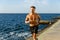 fit adult shirtless man jogging