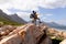 Fit afrcan american couple wearing backpacks hiking embracing on the coast