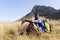 Fit afrcan american man wearing backpack sitting in mountain countryside