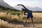 Fit african american man in sportswear stretching in tall grass