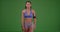 Fit Asian woman athlete stretching on green screen