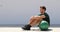 Fit athlete man relaxing at fitness gym during medicine ball workout. Healthy and active lifestyle young adult portrait