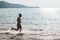 A fit and athletic male jogging barefoot along the coastline. Recreational and low intensity cardio at a scenic beach