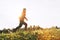 Fit athletic man doing workout warming up exercises before jogging in the autumnal morning. Young fitness male runner stretching l