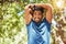 Fit athletic mixed race man smiling while stretching during a workout at the park. Young hispanic man doing warm up