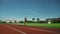 Fit athletic woman jogging on racetrack.