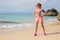 Fit athletic woman standing on the beach ready for workout