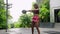 Fit biethnic woman swings kettlebell in outdoor gym. Focus, power in every move of crossfit routine. Dark skin athlete