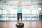 Fit blonde standing on bosu ball and lifting dumbbells