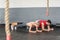 Fit couple planking together in gym