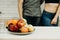 Fit couple snacking with fresh fruits at kitchen