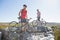 Fit cyclist couple standing at the summit looking around