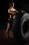 Fit female athlete performing a tire flip