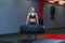 Fit female athlete working out with a huge tire, turning and carry in the gym. Crossfit woman exercising with big tire