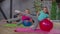 Fit female and child exercising with fitness ball