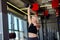 Fit female lifting big iron dumbbell above head at fitness club. Upper body and shoulders training. Female power concept