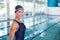 Fit female swimmer by pool at leisure center