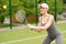 Fit female tennis player plays with aspiration