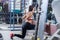Fit girl doing lunges with the smith machine