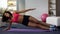 Fit girl doing side plank exercise, working out routine, building up muscles