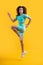 Fit girl isolated on yellow. Energetic girl running studio. Fitness workout. Fitness and sport