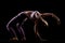 Fit girl practicing yoga in a studio. Half silhouette side lit fitness model