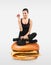 Fit girl sitting on a hamburger holding an apple