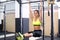 Fit girl training abs by raising legs on a horisontal bar. Fitness woman workout doing exercises at gym.
