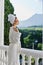 a fit girl in a white robe the balcony overlooks the mountains Perfect sunny morning