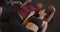 Fit and healthy Black and Hispanic couple laying down on ground after working out in the gym