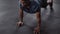 Fit and healthy black male doing push ups at an indoor fitness gym.