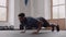 Fit and healthy black male at an indoor fitness gym. Focussed, and preparing for push up exercise.